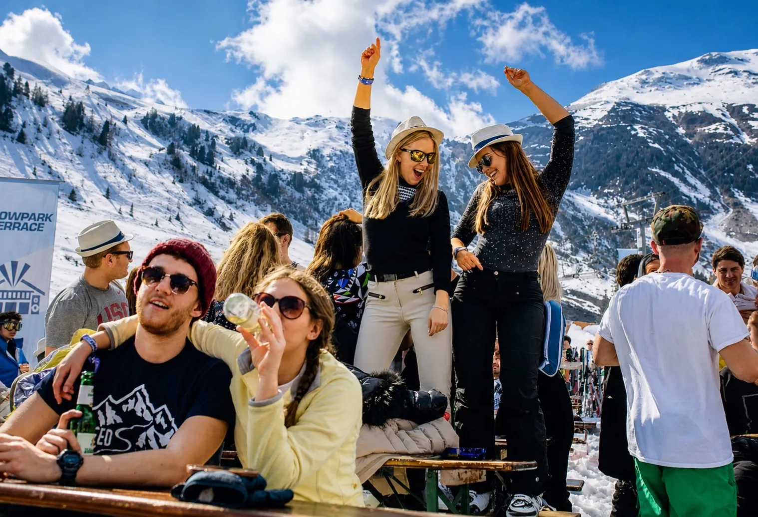 Guests celebrating at a snowy mountain terrace
